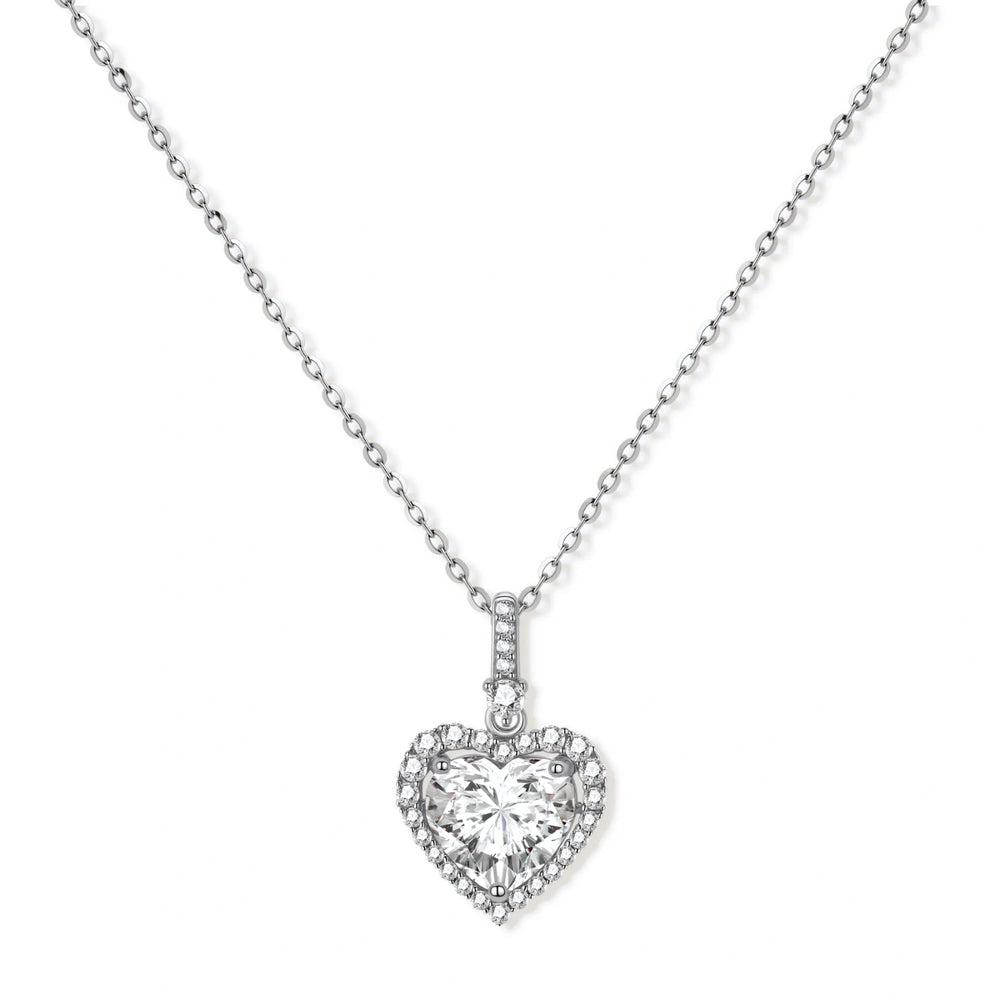 Complete jewelry set with heart-shaped sterling silver pieces featuring brilliant moissanite stones on white background.