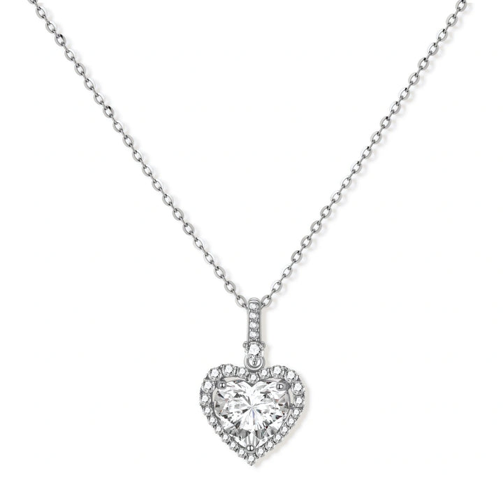 Complete jewelry set with heart-shaped sterling silver pieces featuring brilliant moissanite stones on white background.