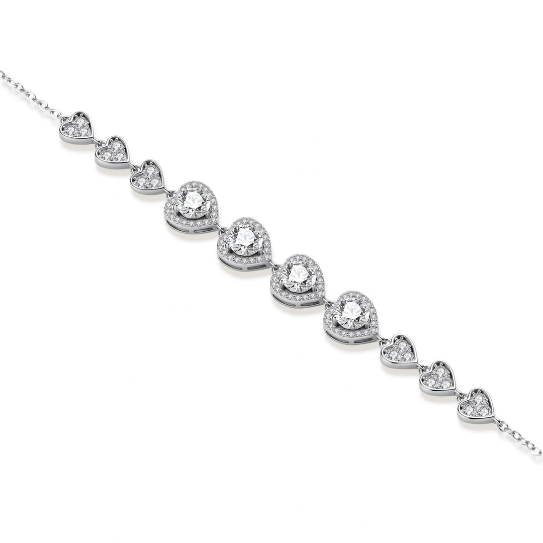 Complete jewelry set with heart-shaped sterling silver pieces featuring brilliant moissanite stones on white background.