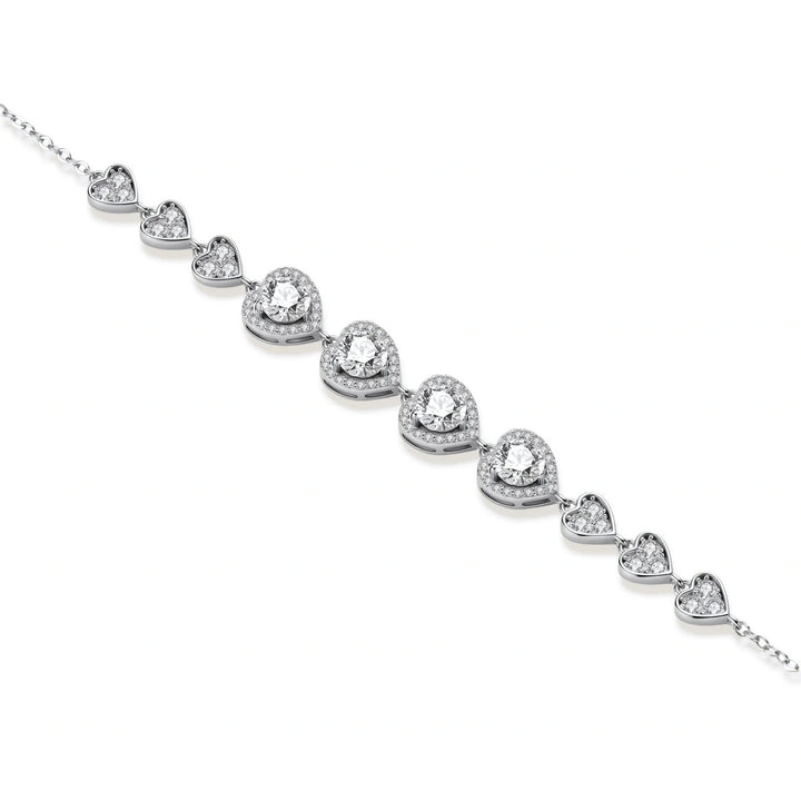 Complete jewelry set with heart-shaped sterling silver pieces featuring brilliant moissanite stones on white background.