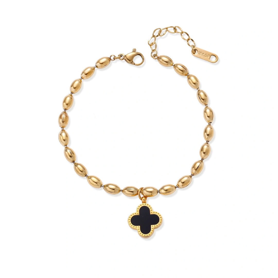 18K gold-plated oval bead chain bracelet with quatrefoil clover charm featuring mother of pearl inlay on cream background